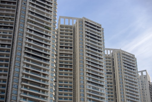 High-rise residential buildings under clear blue sky.