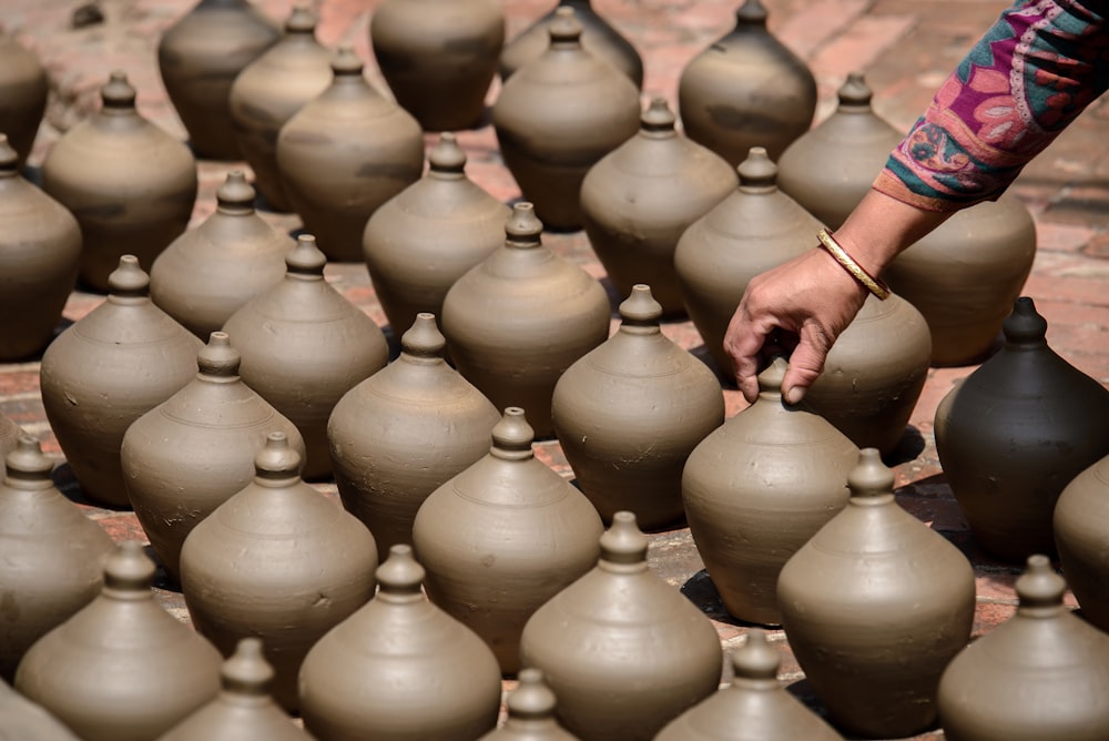 person holding gray pots lid