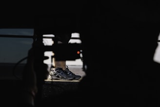 man in black Asics shoes