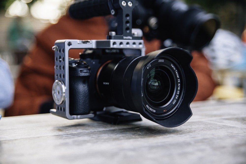 black and gray camera on brown wooden table