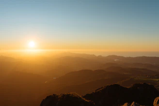 Elegant aerial view of Machu Picchu at sunrise with soft golden light.