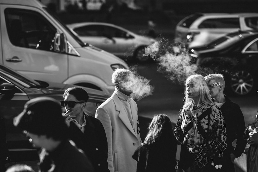 grayscale photography of man smoking beside woman