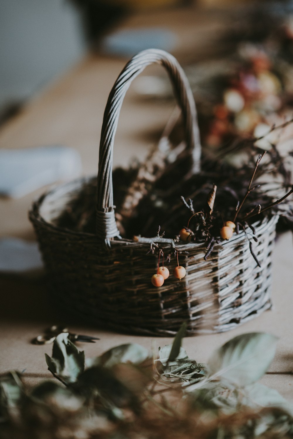 round yellow fruit with twigs in wicker brown basket on top of table inside  room photo – Free Basket Image on Unsplash