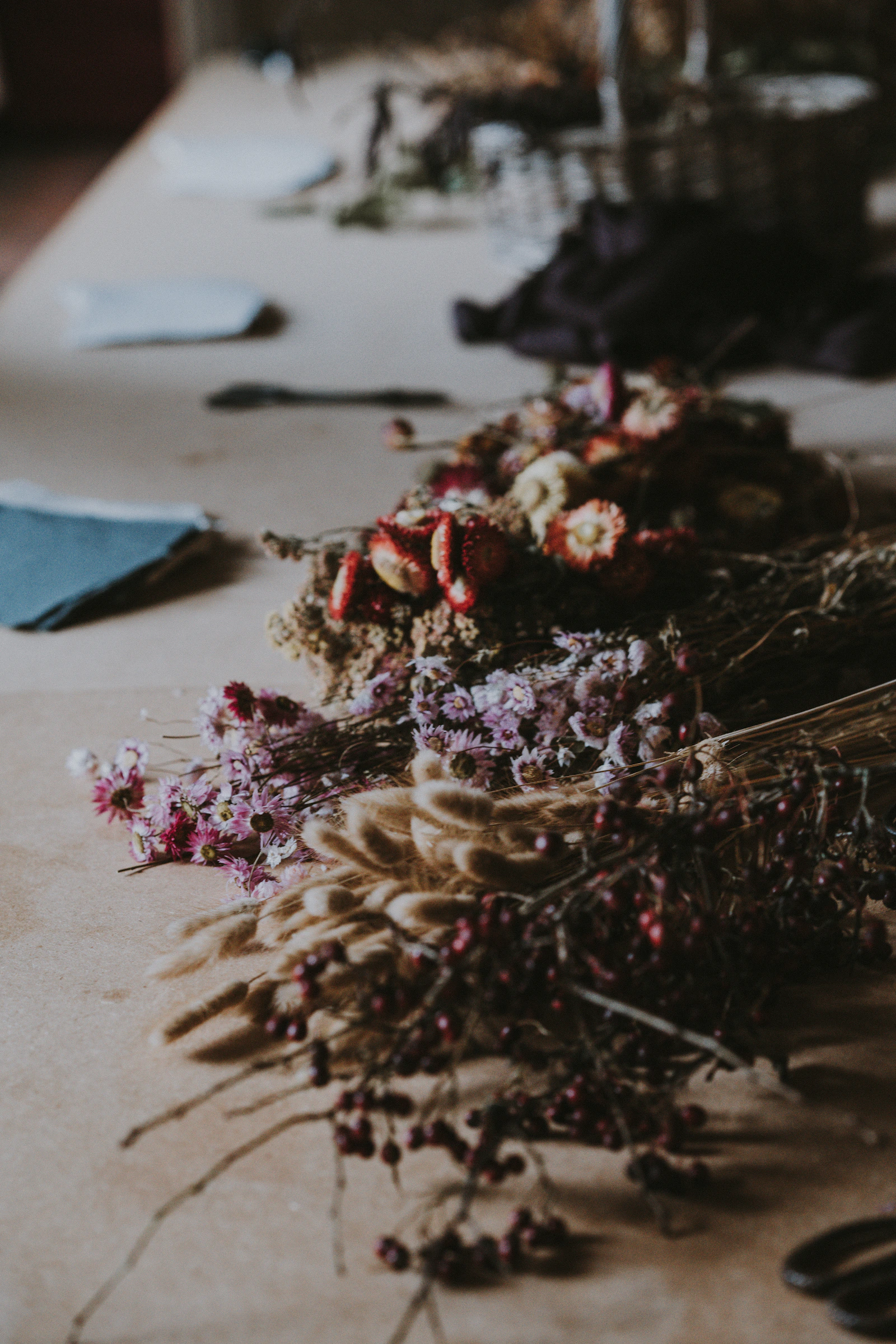 A bouquet of dried flowers resting on a neutral surface