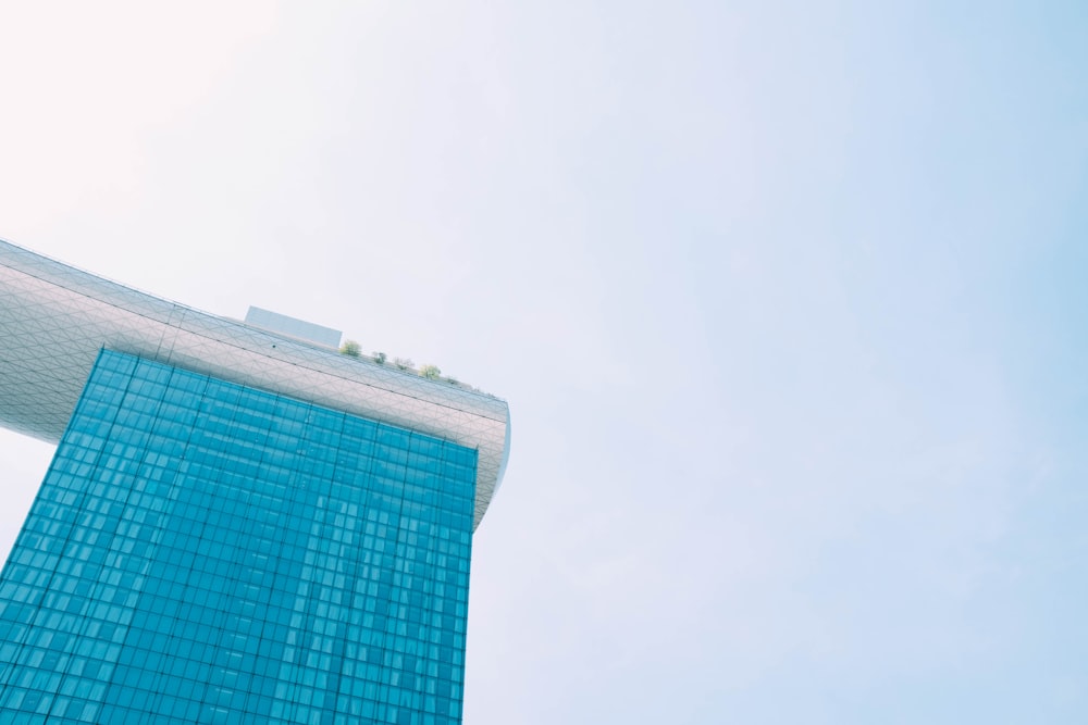 shallow focus photography of teal and gray building under gray sky at daytime