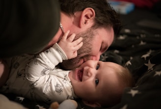 man kissing baby