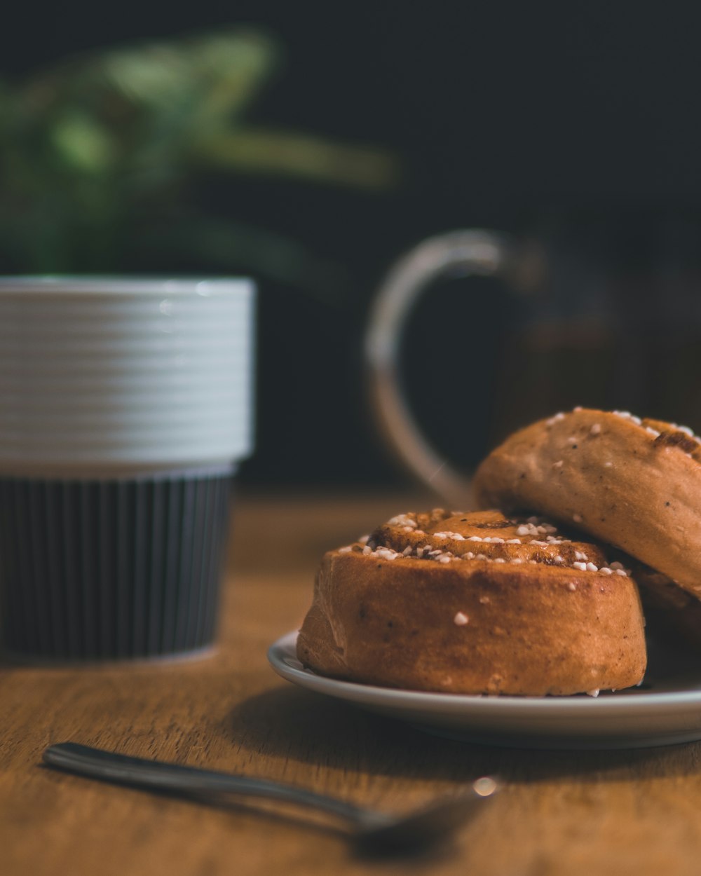 pastry bread with spoon beside and cup