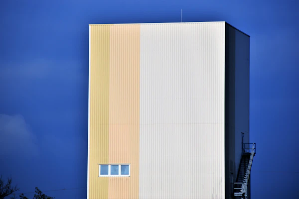 A white block building against a deep blue sky