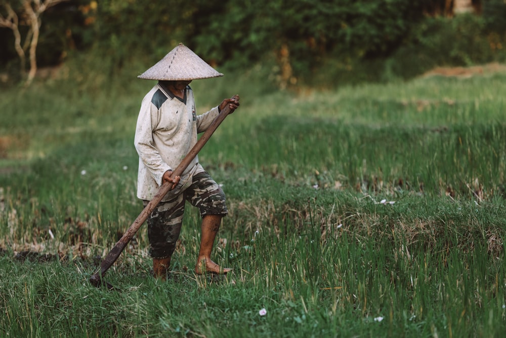 man wearing brown hat standing on grass field