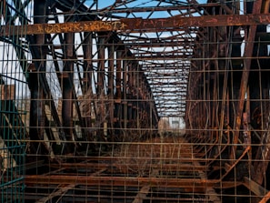A rusted and damaged county bridge with visible structural wear.
