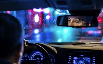 reflective photo of man in rearview mirror