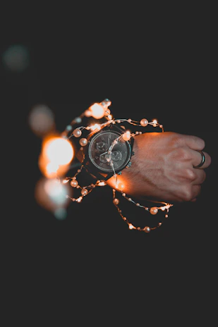 A stylish clip watch attached to a nurse’s uniform pocket, glowing softly under hospital lighting.