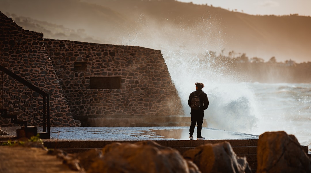 person standing near bwall bricks