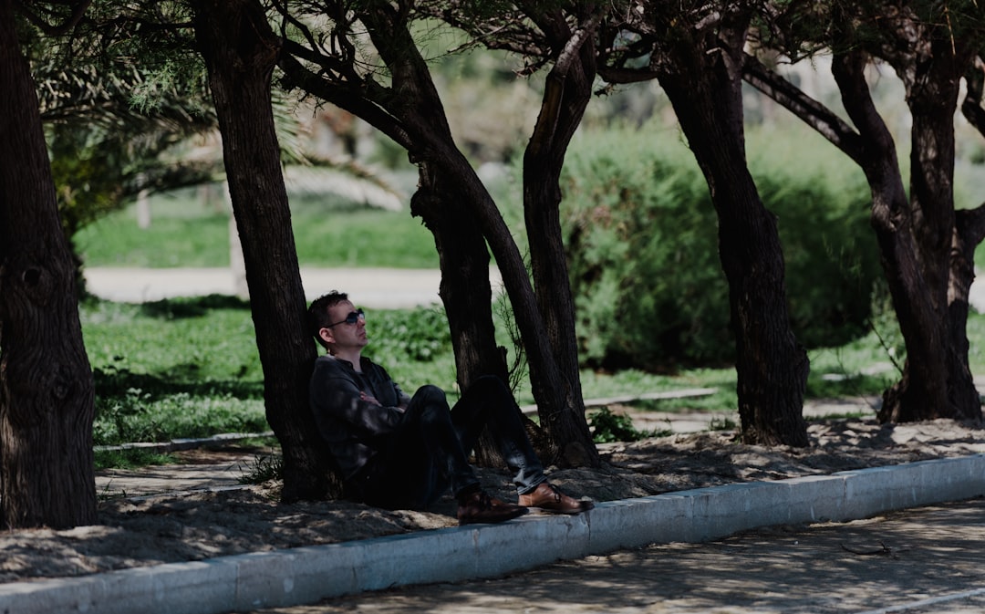 man sitting under tree