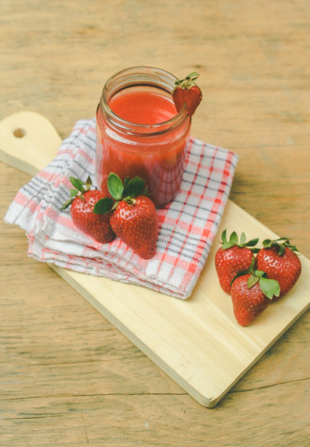 red strawberries on brown chopping board