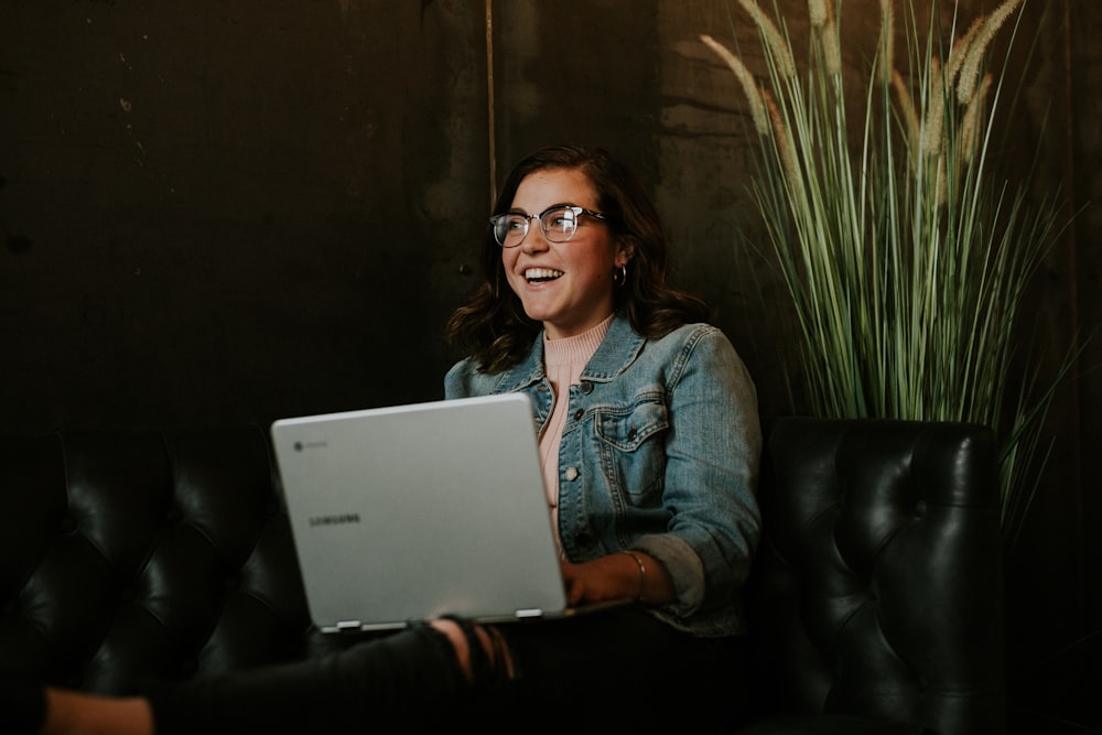 silver laptop on woman's lap