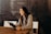 woman sitting around table holding tablet