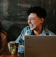 man sitting while using laptop