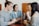 A diverse group of young adults sharing smiles and conversations in a cozy café setting.