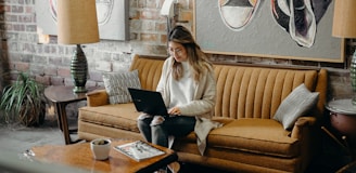 woman using laptop while sitting on chair