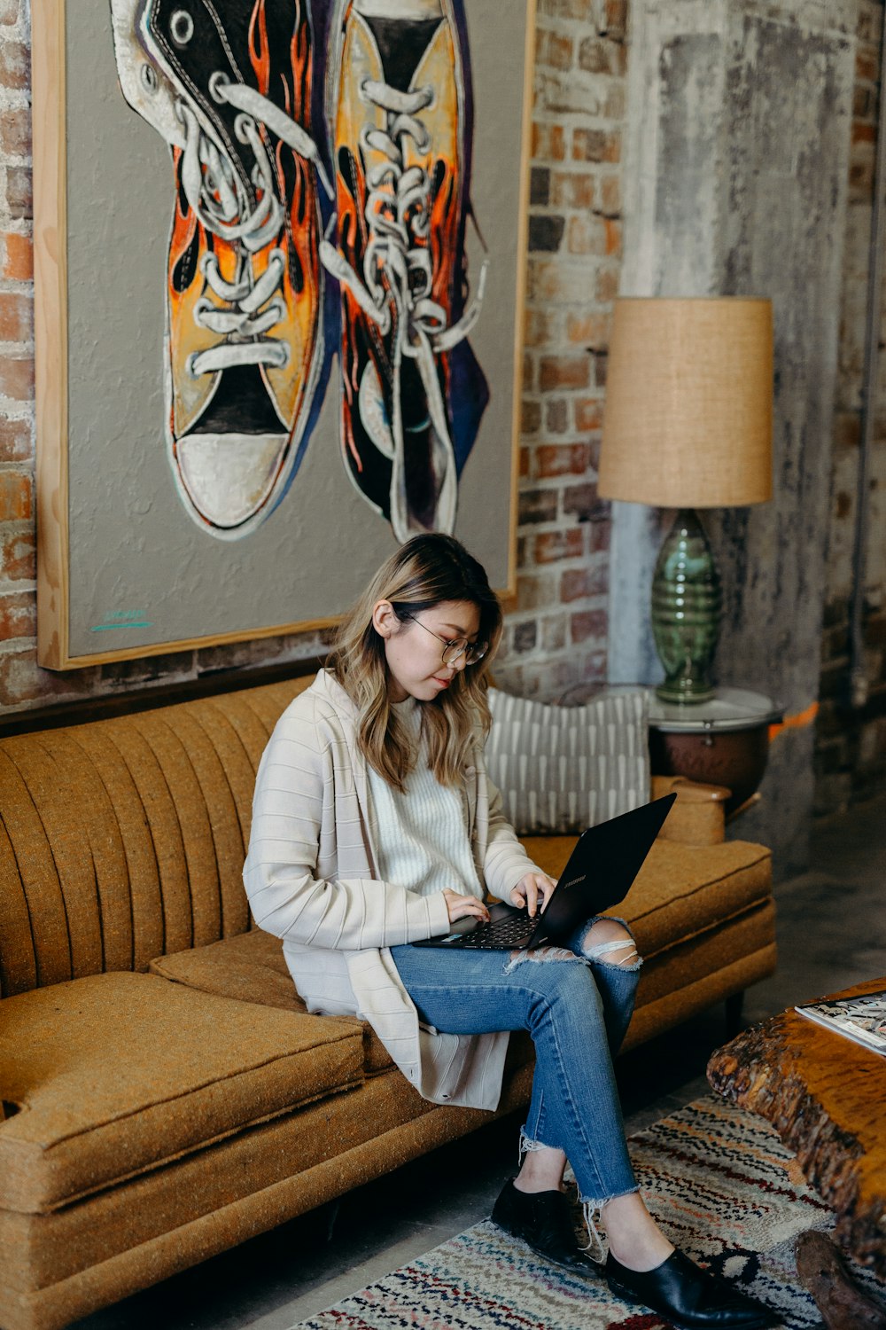 woman using laptop sitting on couch