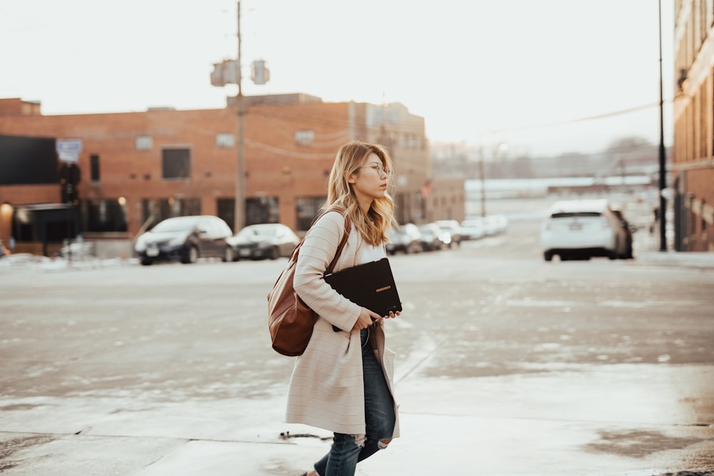 woman crossing street during daytime