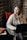woman looking sideways while holding black laptop computer