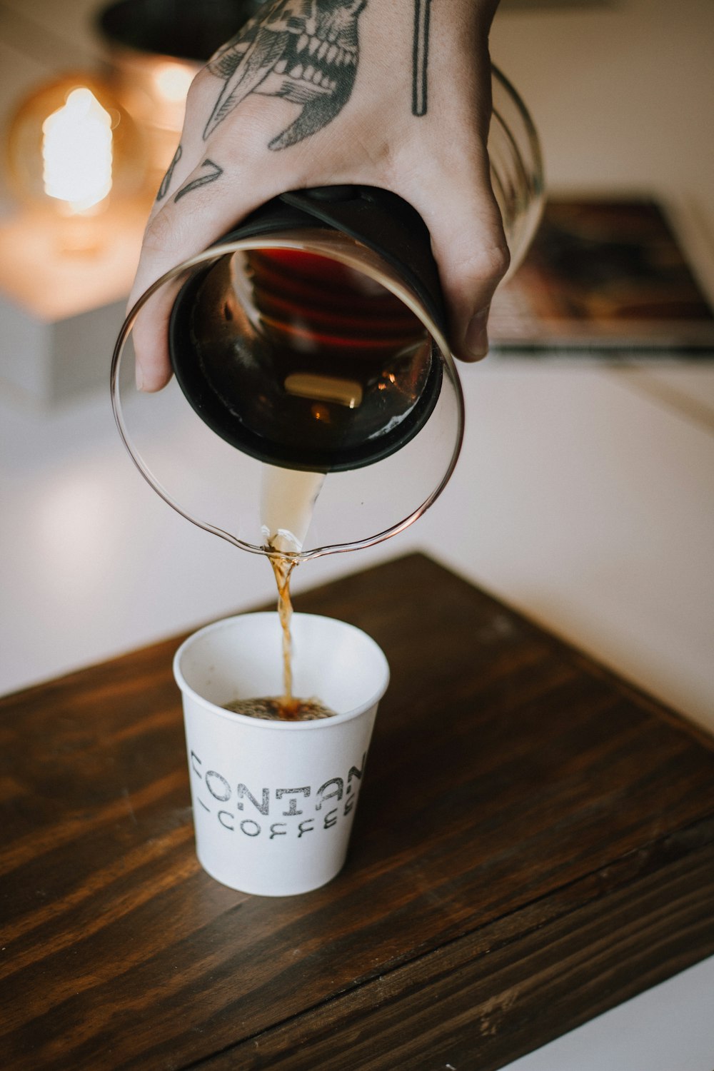 white disposable cup with coffee