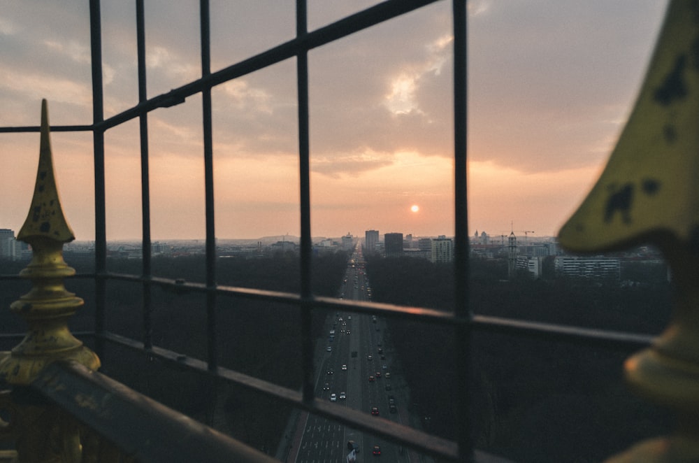 clear glass window showing road during sunset