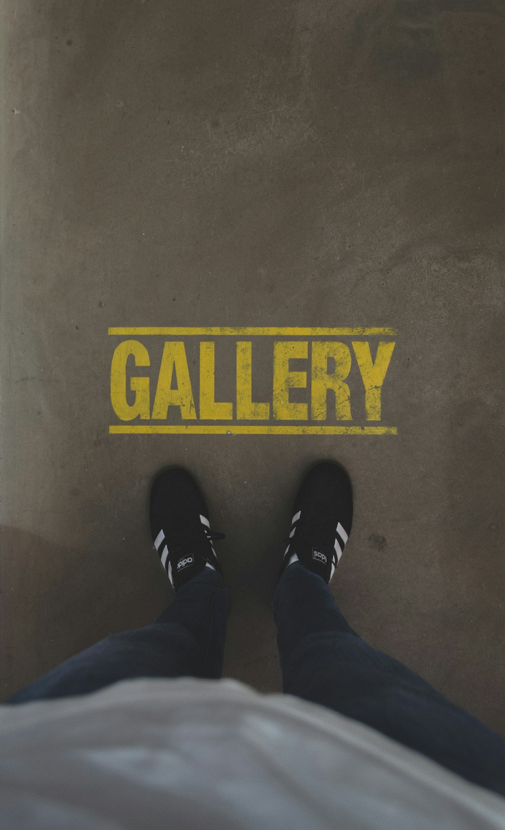 person standing infront of Gallery sign