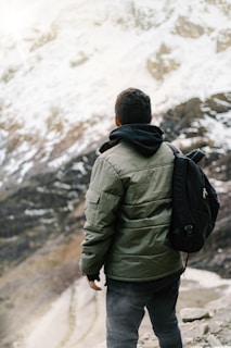 man facing mountain covered with snow