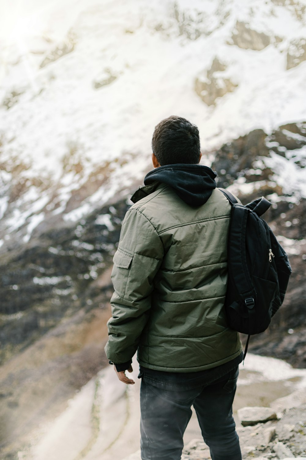 man facing mountain covered with snow