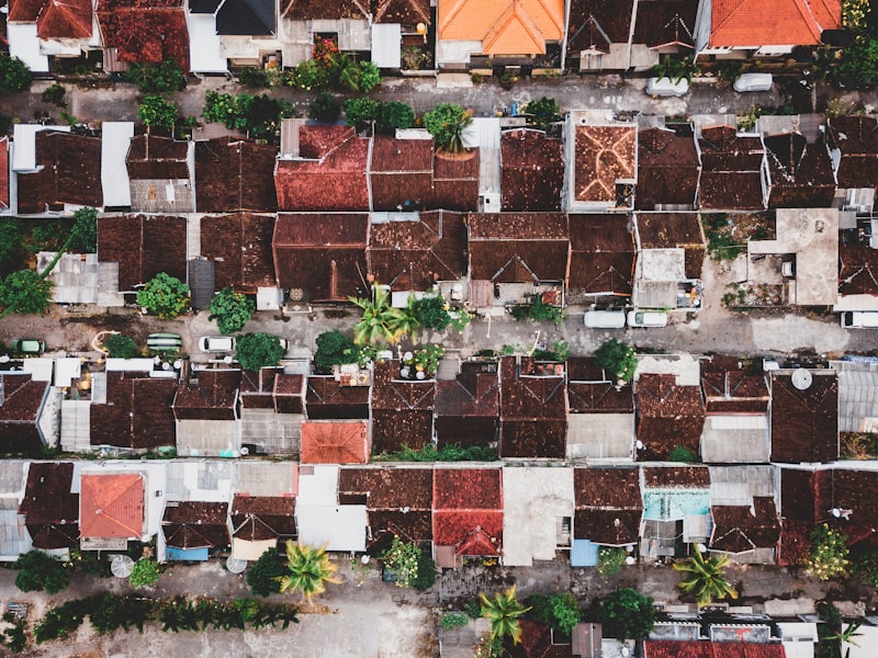 Drone performing roof inspection on residential properties