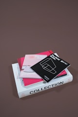 several assorted books stacked on brown surface