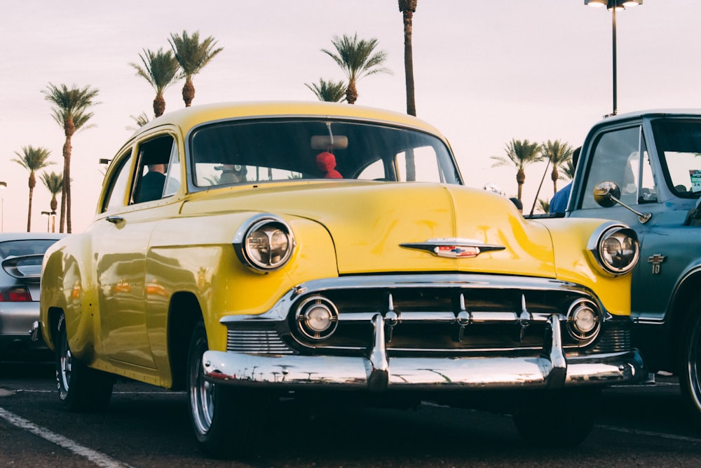 yellow vehicle parked on concrete pavement under white sky