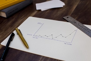 A graph showing upward progress with a person celebrating success.