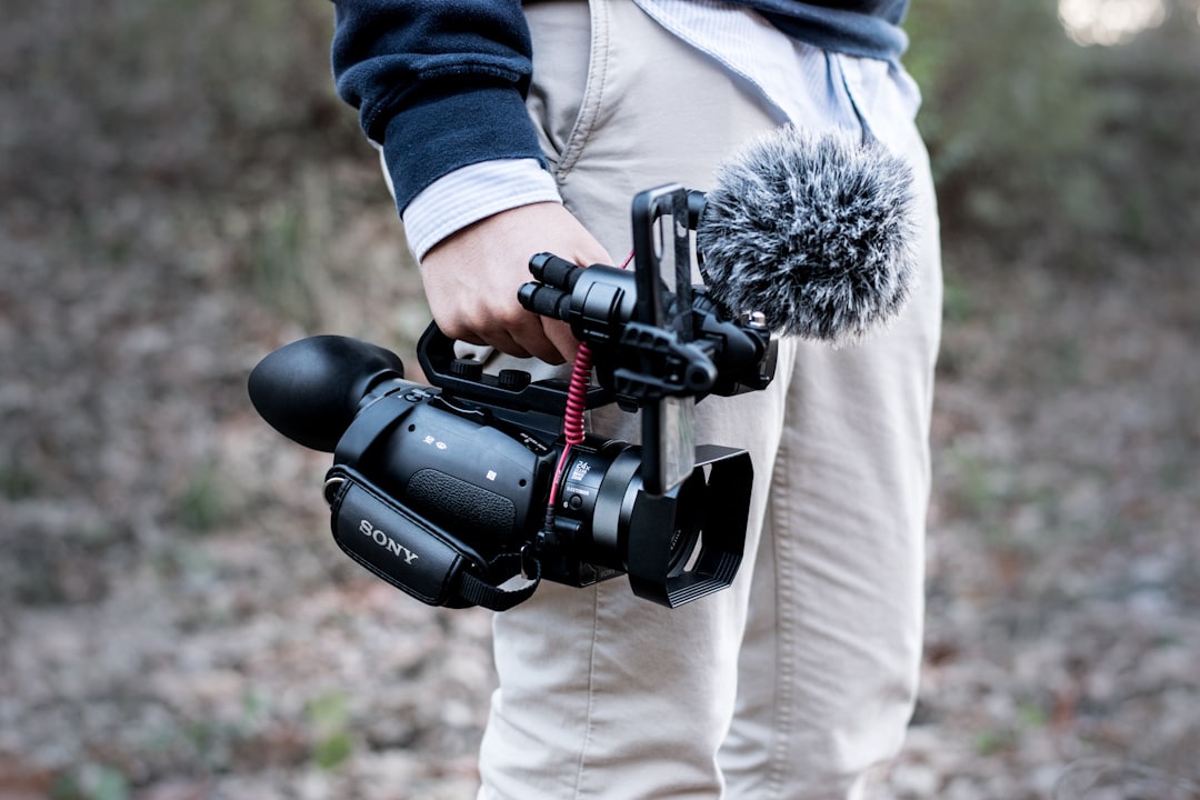 man carrying black Sony video camera