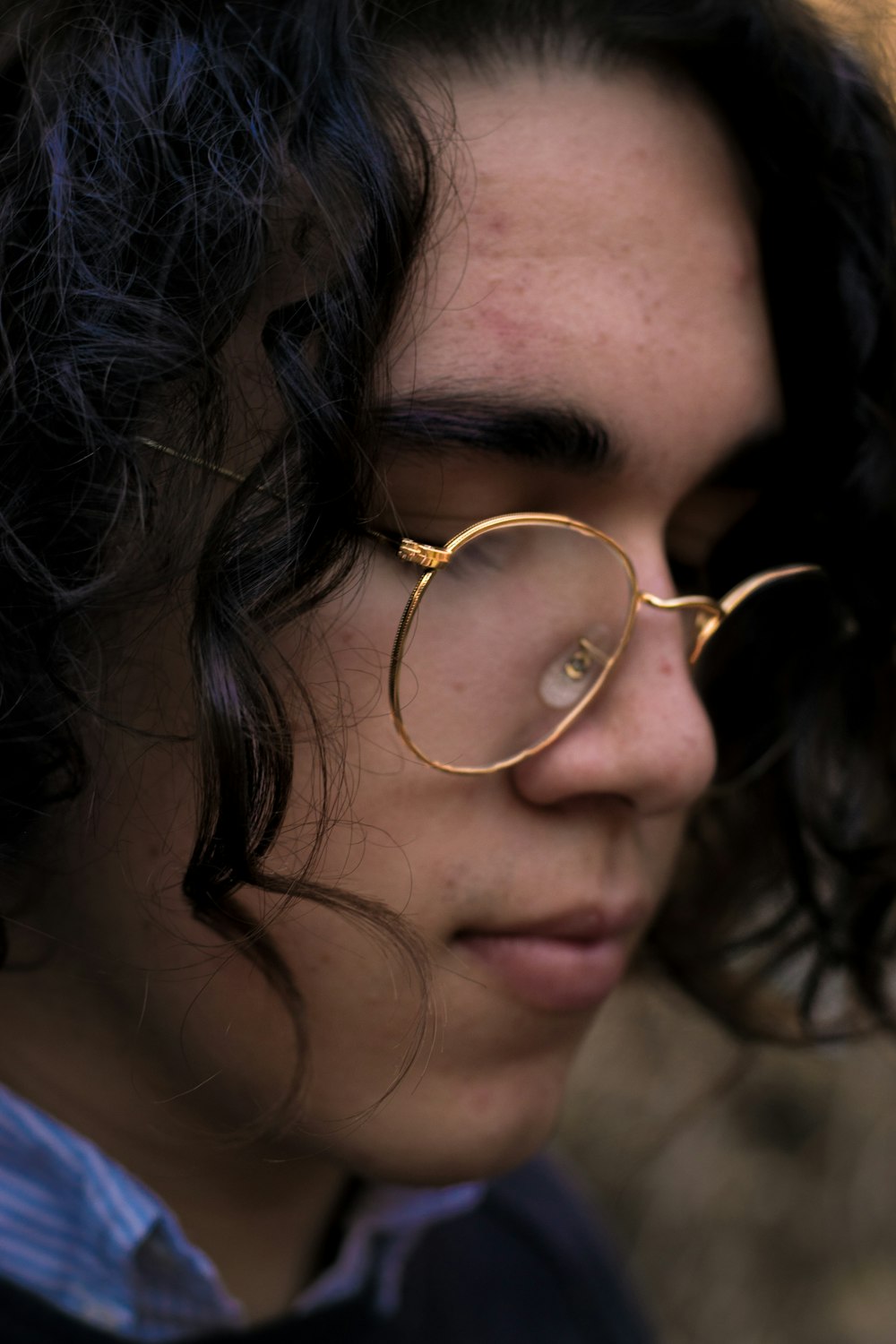 man wearing gold-framed eyeglasses