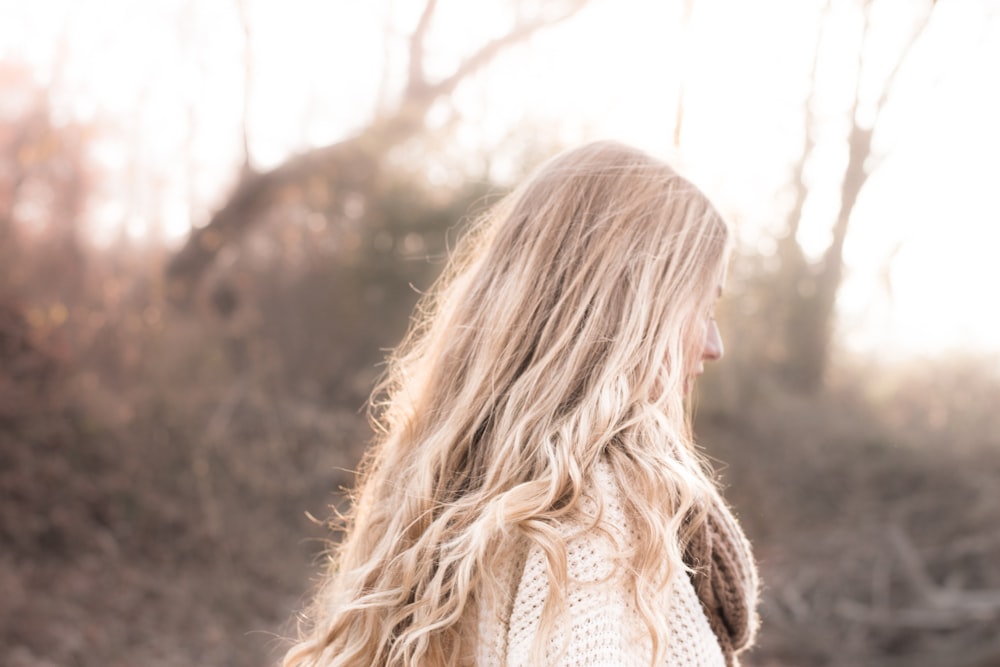 close-up photography of woman wearing beige coat