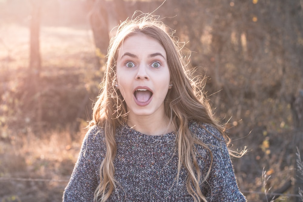 woman standing showing shocking face