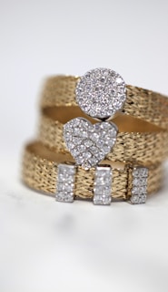 three gold-colored studded rings