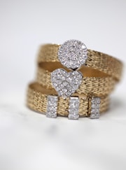 three gold-colored studded rings