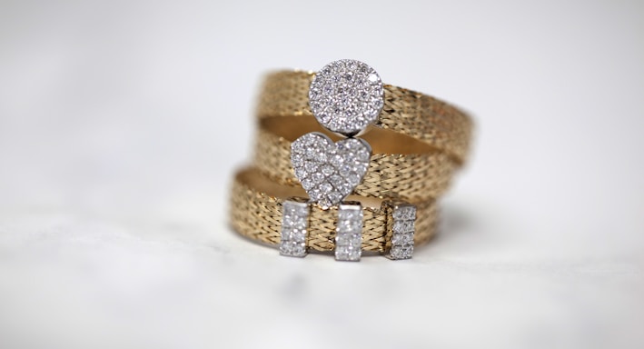 three gold-colored studded rings