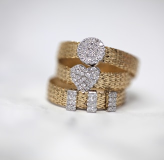 three gold-colored studded rings