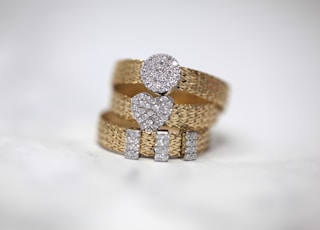 three gold-colored studded rings