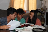 girl and two boys reading books