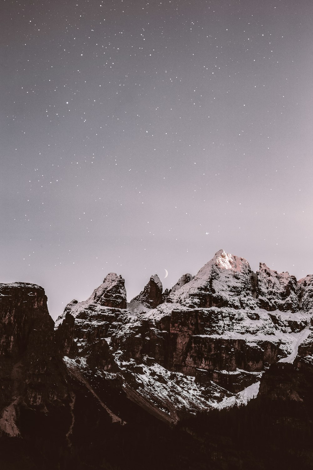 mountain range covered by snow during nighttime