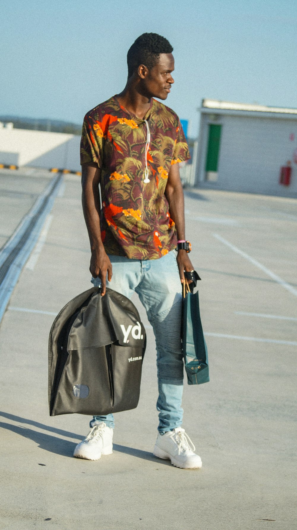 man holding blue shopping bag