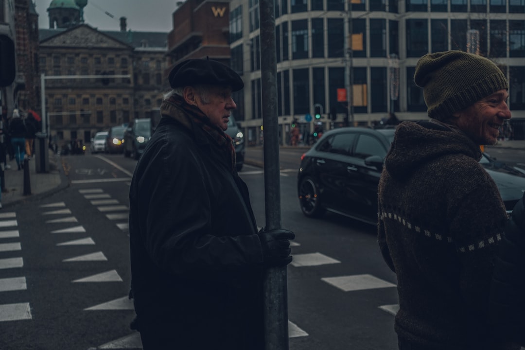 two men wearing black jacket on road during night time