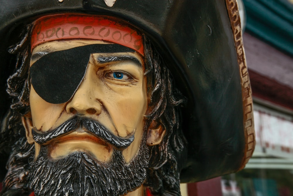man in black pirate hat figurine